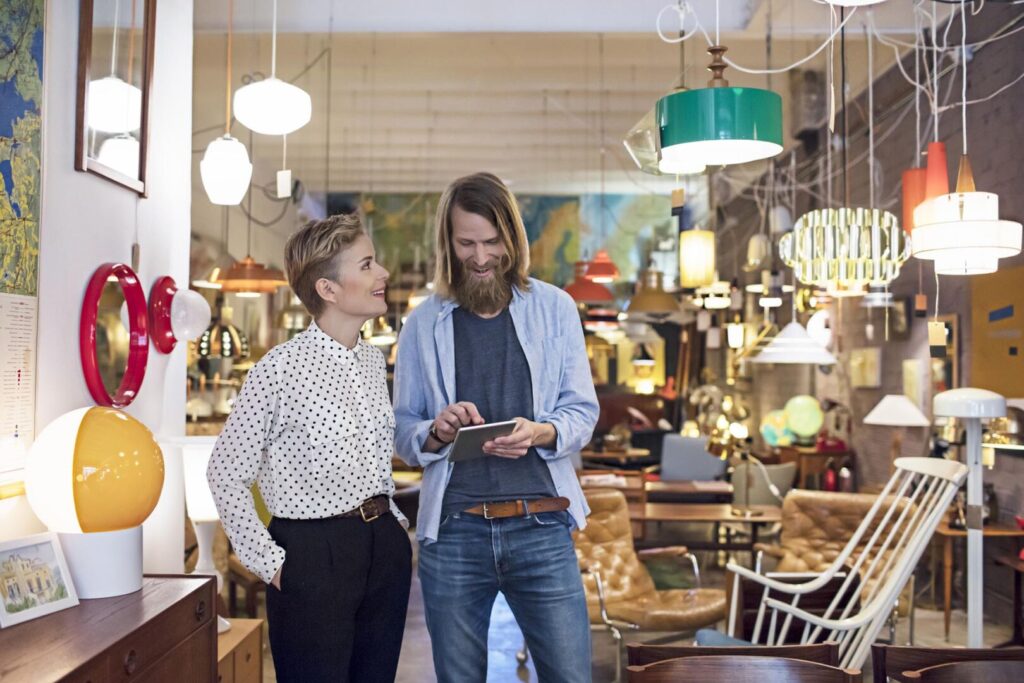 Owners using digital tablet in furniture store