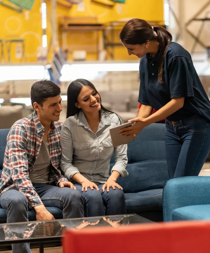 Sales assistant taking an order on a tablet in a furniture showroom