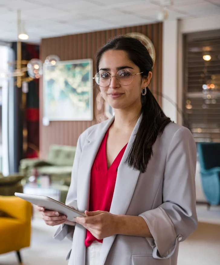 Retail manager checking prices on paperwork in a furniture showroom