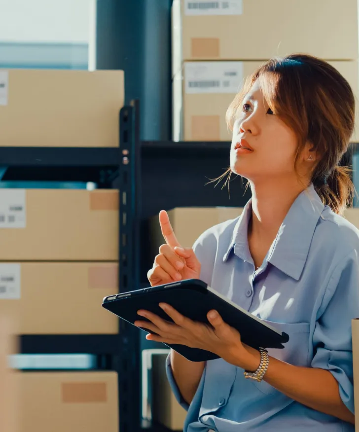 Warehouse assistant checking a delivery on a tablet