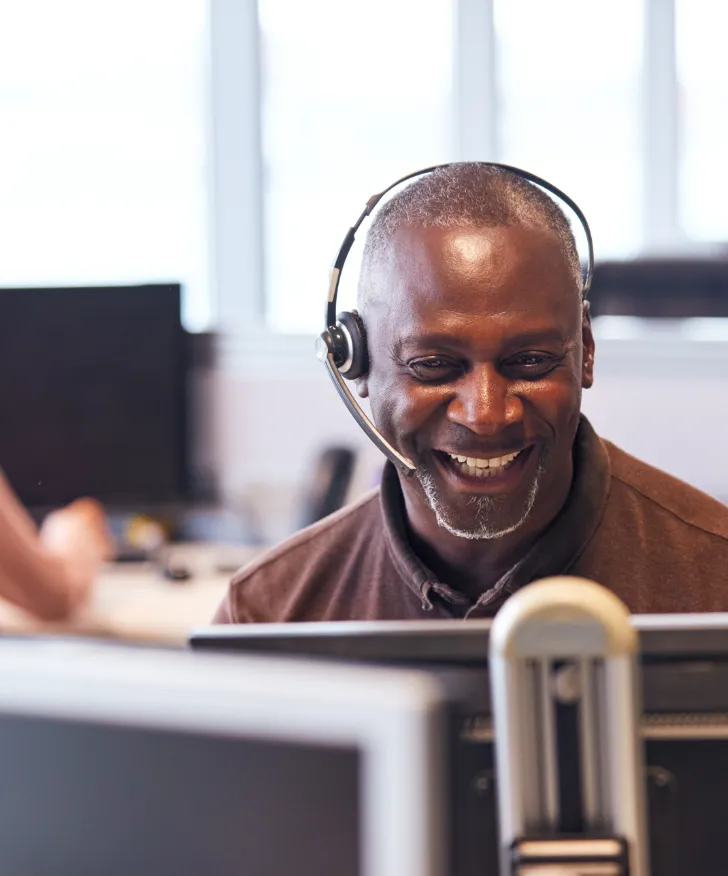 Swan support adviser wearing a headset at his desk